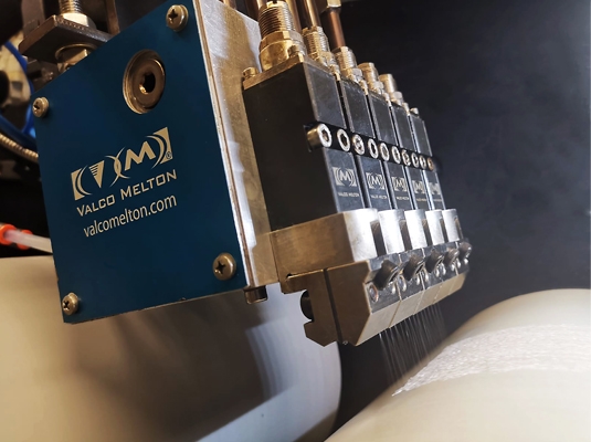 Valco Melton releases the Alpha nozzle, that guarantees clean and uniform spray patterns for diapers and feminine hygiene products.